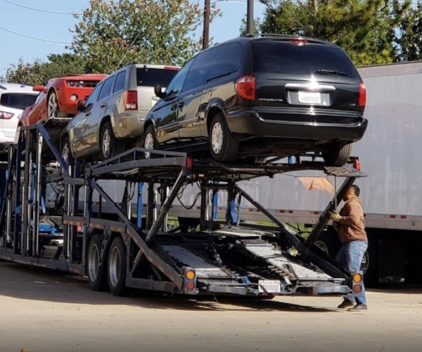 A car transport carrier delivering a vehicle to a customer